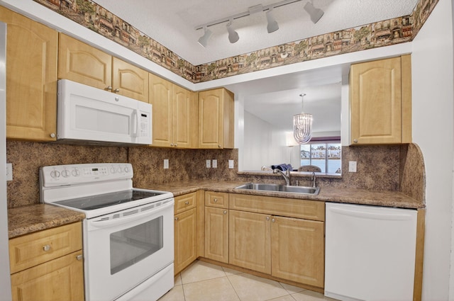 6112 Huntwick Ter Unit 106, Delray Beach, FL 33484 - kitchen with white appliances, light brown cabinetry, a chandelier, and backsplash