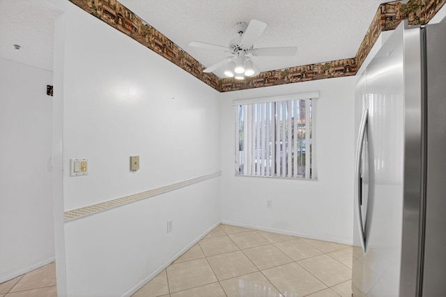 6112 Huntwick Ter Unit 106, Delray Beach, FL 33484 - unfurnished dining area featuring a textured ceiling, light tile patterned flooring, and a ceiling fan
