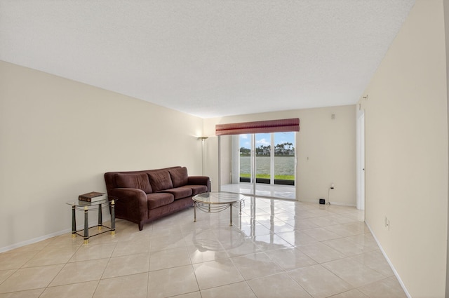 6112 Huntwick Ter Unit 106, Delray Beach, FL 33484 - living area with light tile patterned floors and baseboards