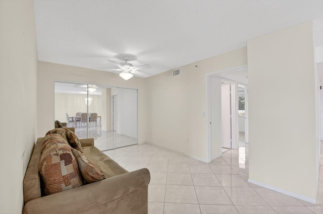 6112 Huntwick Ter Unit 106, Delray Beach, FL 33484 - living room featuring light tile patterned floors and a ceiling fan