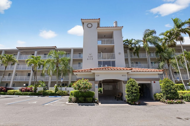 6112 Huntwick Ter Unit 106, Delray Beach, FL 33484 - view of apartment building / complex featuring uncovered parking