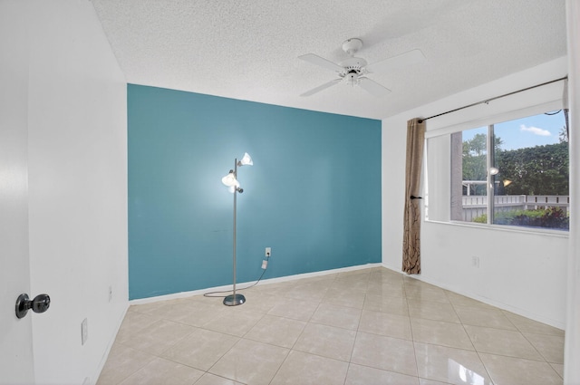6112 Huntwick Ter Unit 106, Delray Beach, FL 33484 - tiled spare room featuring a textured ceiling and ceiling fan