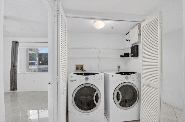 6112 Huntwick Ter Unit 106, Delray Beach, FL 33484 - laundry area with separate washer and dryer, light tile patterned floors, and a textured ceiling