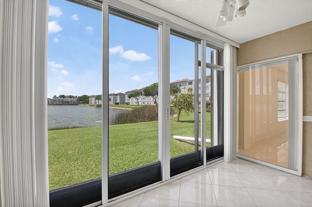 6112 Huntwick Ter Unit 106, Delray Beach, FL 33484 - unfurnished sunroom featuring a water view, a ceiling fan, and plenty of natural light