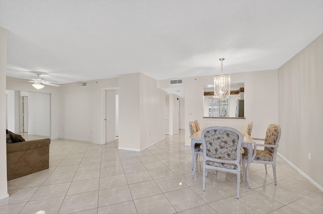 6112 Huntwick Ter Unit 106, Delray Beach, FL 33484 - dining room with a chandelier, light tile patterned flooring, ceiling fan, and a textured ceiling