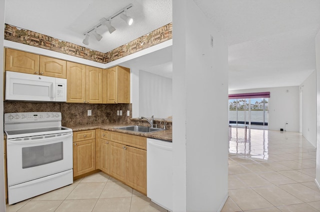 6112 Huntwick Ter Unit 106, Delray Beach, FL 33484 - kitchen featuring white appliances, light tile patterned flooring, backsplash, light brown cabinetry, and rail lighting
