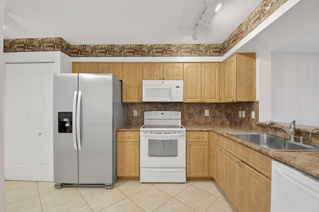 6112 Huntwick Ter Unit 106, Delray Beach, FL 33484 - kitchen with white appliances, light tile patterned floors, decorative backsplash, and light brown cabinets