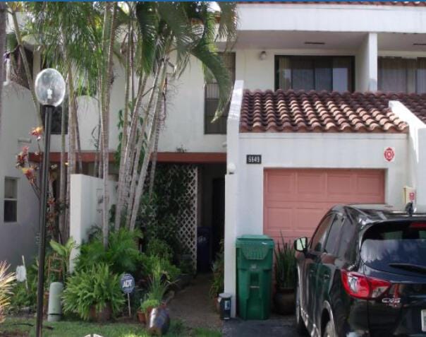 6649 Racquet Club Dr Unit 173, Lauderhill, FL 33319 - view of front facade featuring stucco siding, a garage, and a tile roof