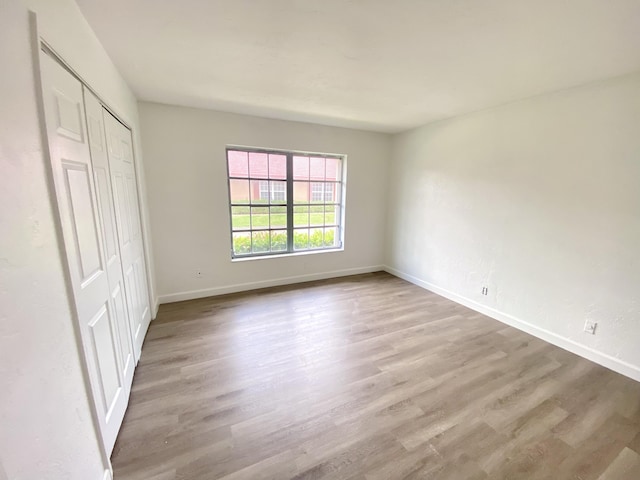1430 SW 25th Way Unit B, Boynton Beach, FL 33426 - unfurnished bedroom featuring wood finished floors and a closet