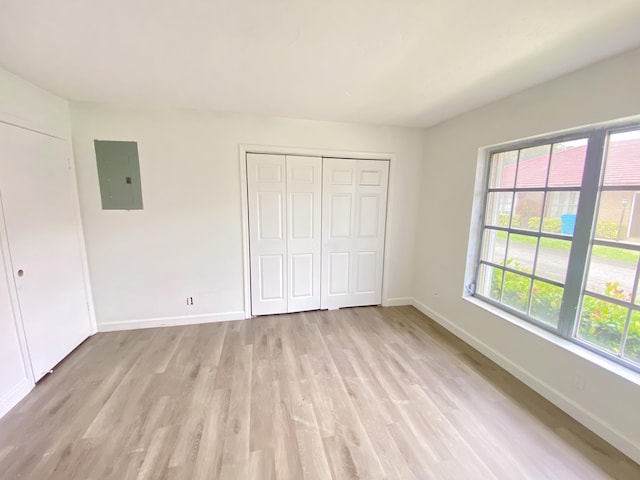 1430 SW 25th Way Unit B, Boynton Beach, FL 33426 - unfurnished bedroom featuring electric panel, light wood finished floors, and a closet
