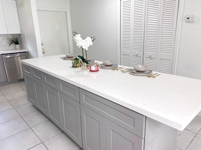 1430 SW 25th Way Unit B, Boynton Beach, FL 33426 - kitchen with dishwasher, gray cabinets, light tile patterned floors, and light stone counters