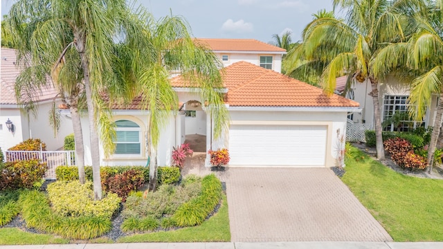 7121 NW Turtle Walk, Boca Raton, FL 33487 - mediterranean / spanish house featuring a garage, decorative driveway, a tiled roof, and stucco siding