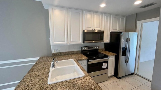 2039 Tarpon Lake Way, West Palm Beach, FL 33411 - kitchen with stainless steel appliances, a sink, white cabinetry, recessed lighting, and light tile patterned floors