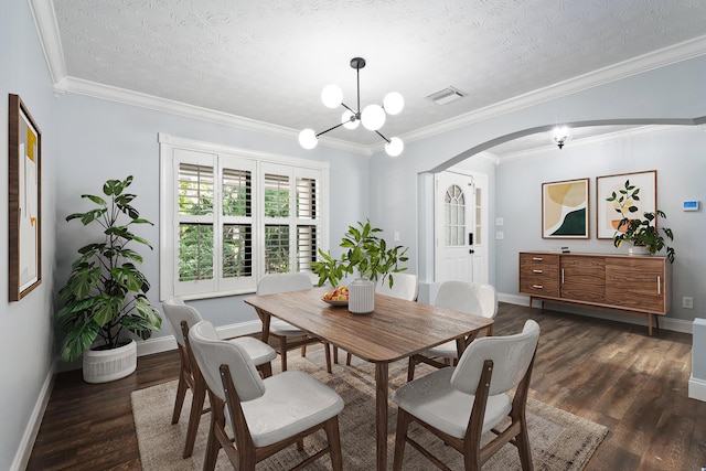 2130 W Boothe Dr, Fort Pierce, FL 34982 - dining area featuring arched walkways, a textured ceiling, dark wood-type flooring, baseboards, and a chandelier