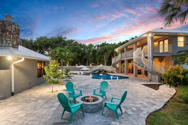 2130 W Boothe Dr, Fort Pierce, FL 34982 - swimming pool with an outdoor fire pit, stairway, a fenced backyard, and a patio