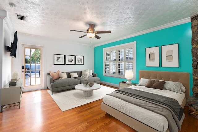 2130 W Boothe Dr, Fort Pierce, FL 34982 - bedroom featuring access to exterior, wood finished floors, crown molding, ceiling fan, and a textured ceiling