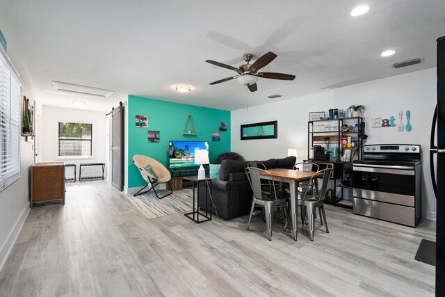 2130 W Boothe Dr, Fort Pierce, FL 34982 - dining space featuring a barn door, a ceiling fan, light wood-style flooring, baseboards, and recessed lighting