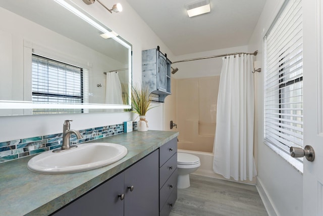 2130 W Boothe Dr, Fort Pierce, FL 34982 - bathroom featuring vanity, toilet, shower / tub combo with curtain, and wood finished floors