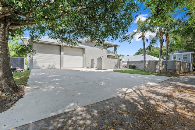 2130 W Boothe Dr, Fort Pierce, FL 34982 - mid-century inspired home with concrete driveway, stucco siding, and a garage
