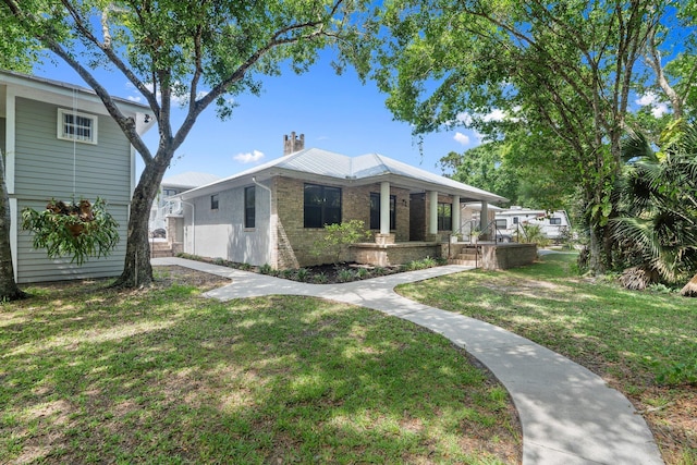 2130 W Boothe Dr, Fort Pierce, FL 34982 - back of property with a porch, a lawn, and brick siding