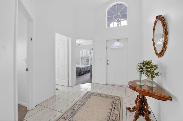 23440 Serene Meadow Dr S, Boca Raton, FL 33428 - foyer entrance with baseboards, light tile patterned flooring, and a towering ceiling