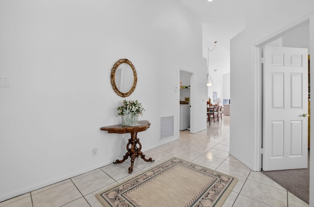 23440 Serene Meadow Dr S, Boca Raton, FL 33428 - hall featuring light tile patterned flooring, a high ceiling, and baseboards