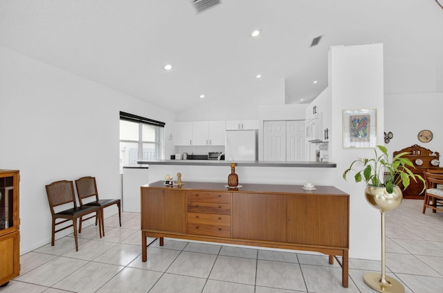 23440 Serene Meadow Dr S, Boca Raton, FL 33428 - kitchen with white cabinets, a peninsula, light tile patterned floors, lofted ceiling, and recessed lighting