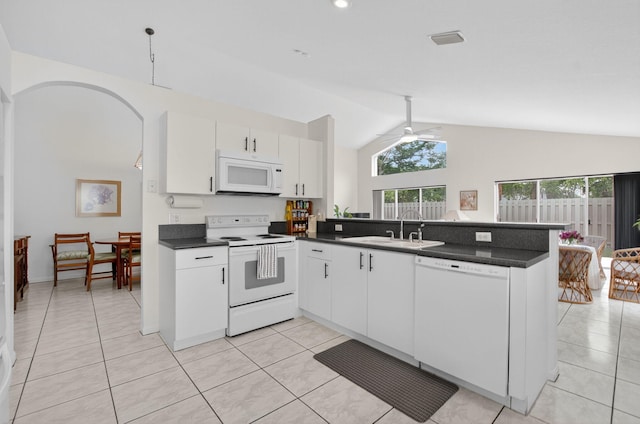 23440 Serene Meadow Dr S, Boca Raton, FL 33428 - kitchen with white appliances, a sink, a peninsula, vaulted ceiling, and light tile patterned floors