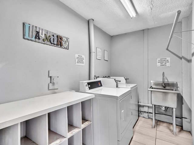 9855 Sandalfoot Blvd Unit 320, Boca Raton, FL 33428 - shared laundry featuring washer and clothes dryer and a textured ceiling