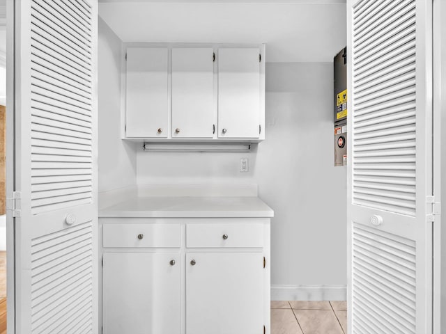 9855 Sandalfoot Blvd Unit 320, Boca Raton, FL 33428 - kitchen featuring light countertops, white cabinetry, and light tile patterned floors