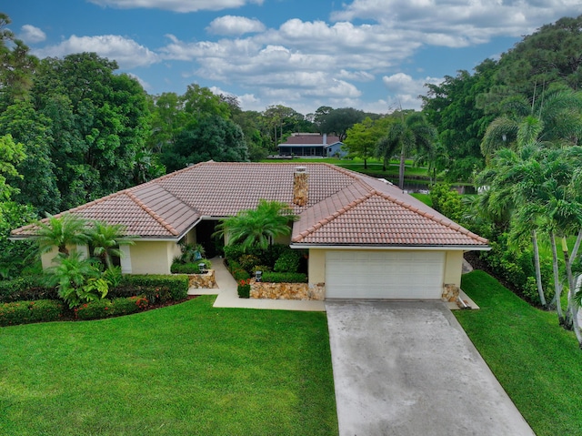 2413 NW 26th St, Boca Raton, FL 33431 - mediterranean / spanish-style house featuring stucco siding, a tile roof, and a front lawn
