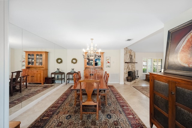 2413 NW 26th St, Boca Raton, FL 33431 - dining space featuring a chandelier, light tile patterned floors, and a fireplace