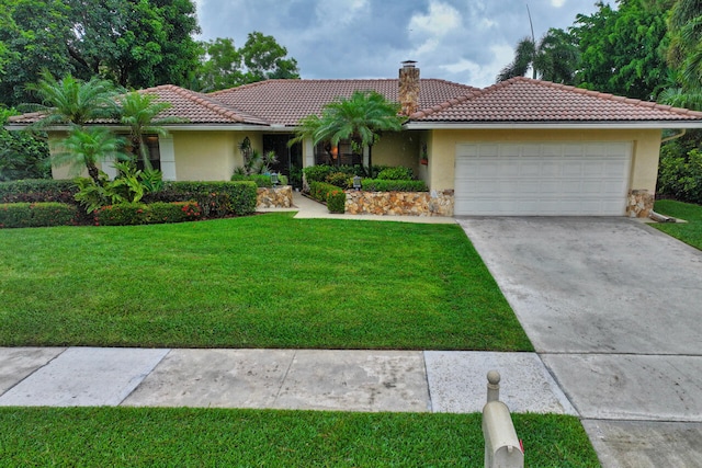 2413 NW 26th St, Boca Raton, FL 33431 - view of front of home featuring a tile roof, a front lawn, an attached garage, and stucco siding