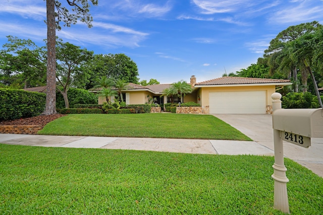 2413 NW 26th St, Boca Raton, FL 33431 - single story home with stucco siding, a garage, driveway, a front lawn, and a chimney