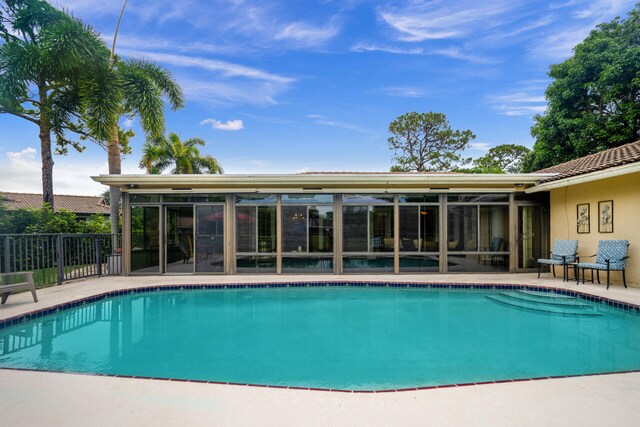 2413 NW 26th St, Boca Raton, FL 33431 - view of pool with a sunroom and a patio area