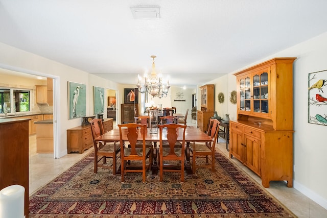 2413 NW 26th St, Boca Raton, FL 33431 - dining room featuring a chandelier, light tile patterned floors, and baseboards