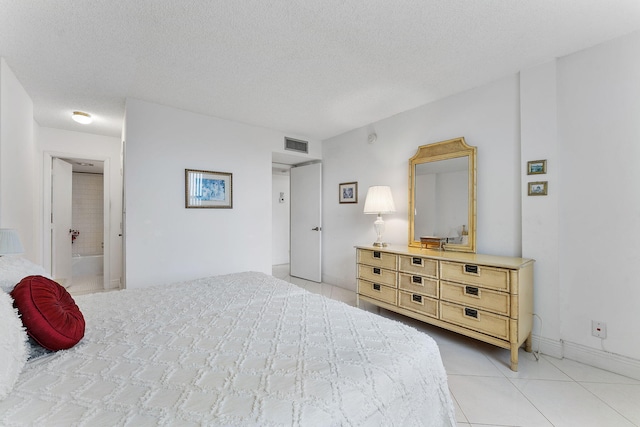 1009 N Ocean Blvd Unit 511, Pompano Beach, FL 33062 - bedroom with light tile patterned floors, a textured ceiling, and baseboards