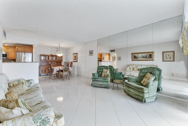1009 N Ocean Blvd Unit 511, Pompano Beach, FL 33062 - living room featuring a chandelier, light tile patterned floors, and a textured ceiling