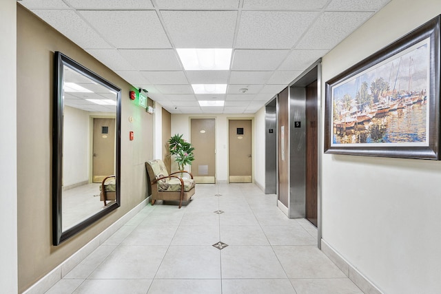 1009 N Ocean Blvd Unit 511, Pompano Beach, FL 33062 - hall with a paneled ceiling, elevator, light tile patterned floors, and baseboards