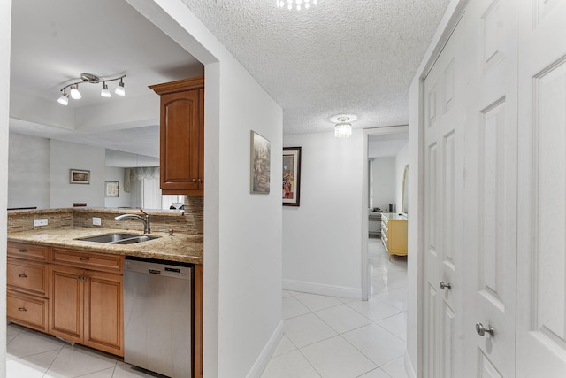 1009 N Ocean Blvd Unit 511, Pompano Beach, FL 33062 - kitchen with stainless steel dishwasher, a sink, light tile patterned floors, baseboards, and a textured ceiling