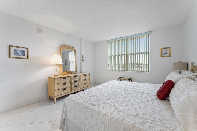 1009 N Ocean Blvd Unit 511, Pompano Beach, FL 33062 - bedroom featuring light tile patterned floors, a textured ceiling, and baseboards