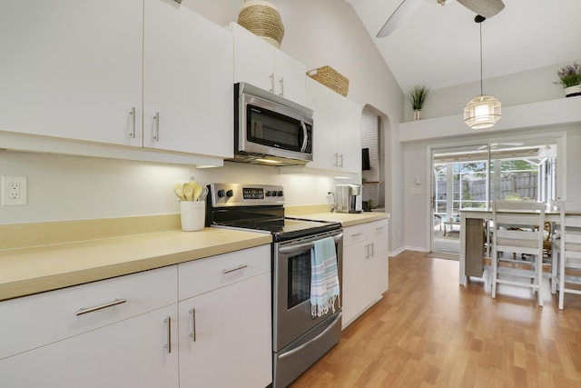 2633 SE Export Ave, Port Saint Lucie, FL 34952 - kitchen featuring appliances with stainless steel finishes, decorative light fixtures, light wood-style flooring, light countertops, and high vaulted ceiling