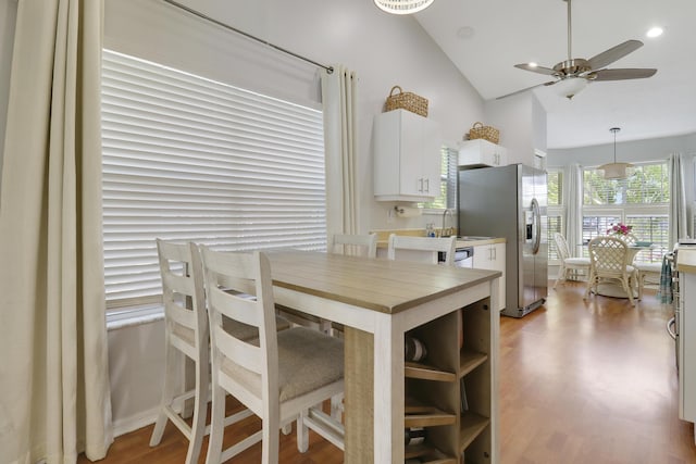 2633 SE Export Ave, Port Saint Lucie, FL 34952 - dining space with a ceiling fan, wood finished floors, and high vaulted ceiling