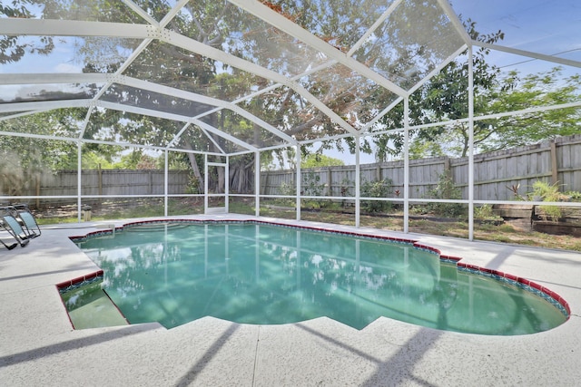 2633 SE Export Ave, Port Saint Lucie, FL 34952 - view of swimming pool featuring a fenced backyard, a lanai, and a patio area