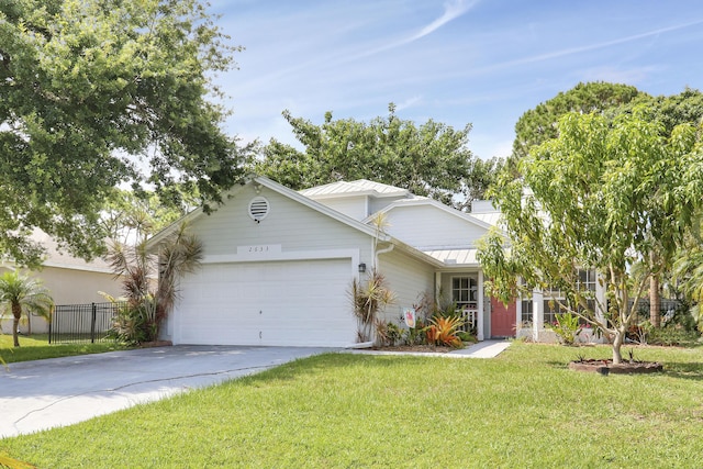 2633 SE Export Ave, Port Saint Lucie, FL 34952 - ranch-style house with an attached garage, driveway, metal roof, and a standing seam roof