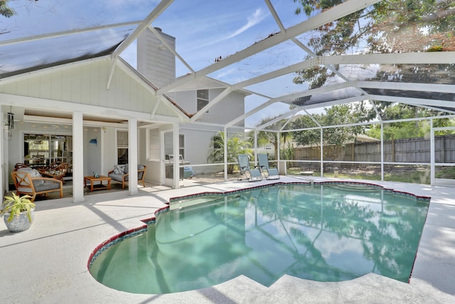 2633 SE Export Ave, Port Saint Lucie, FL 34952 - view of swimming pool featuring a patio area, glass enclosure, and outdoor lounge area