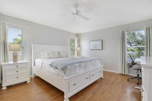 2633 SE Export Ave, Port Saint Lucie, FL 34952 - bedroom with light wood-style flooring, an office area, baseboards, and a ceiling fan