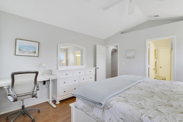 2633 SE Export Ave, Port Saint Lucie, FL 34952 - bedroom with wood finished floors, vaulted ceiling, ensuite bathroom, ceiling fan, and an office area