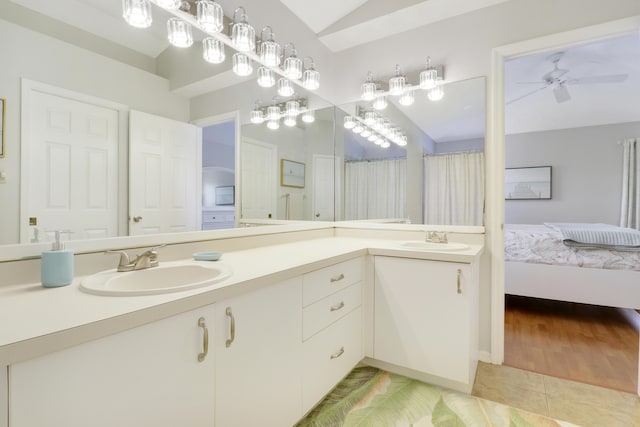 2633 SE Export Ave, Port Saint Lucie, FL 34952 - ensuite bathroom featuring double vanity, tile patterned floors, ceiling fan, and lofted ceiling