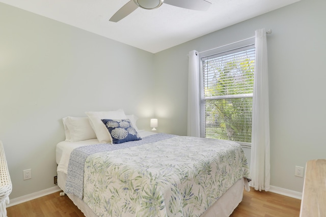 2633 SE Export Ave, Port Saint Lucie, FL 34952 - bedroom featuring wood finished floors, baseboards, and ceiling fan